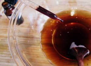 Add herbal tincture if desired. Add sweetener and stir until dissolved.  Mix in herbal tea or juice and stir well.